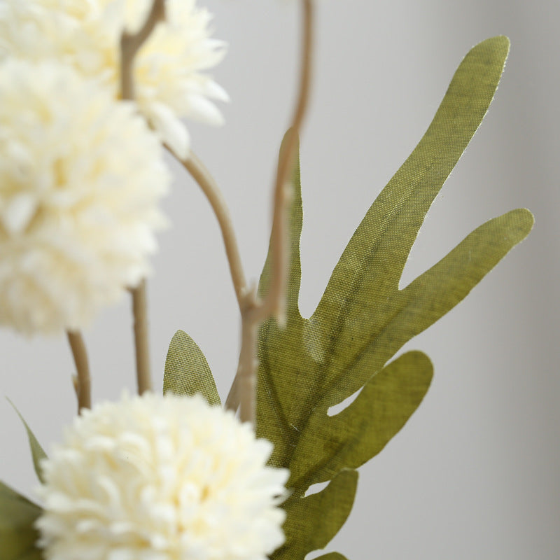 Artificial flowers with decorative greenery
