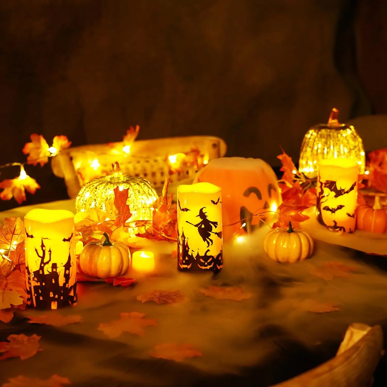 Halloween candle table centerpiece with pumpkins and autumn leaves