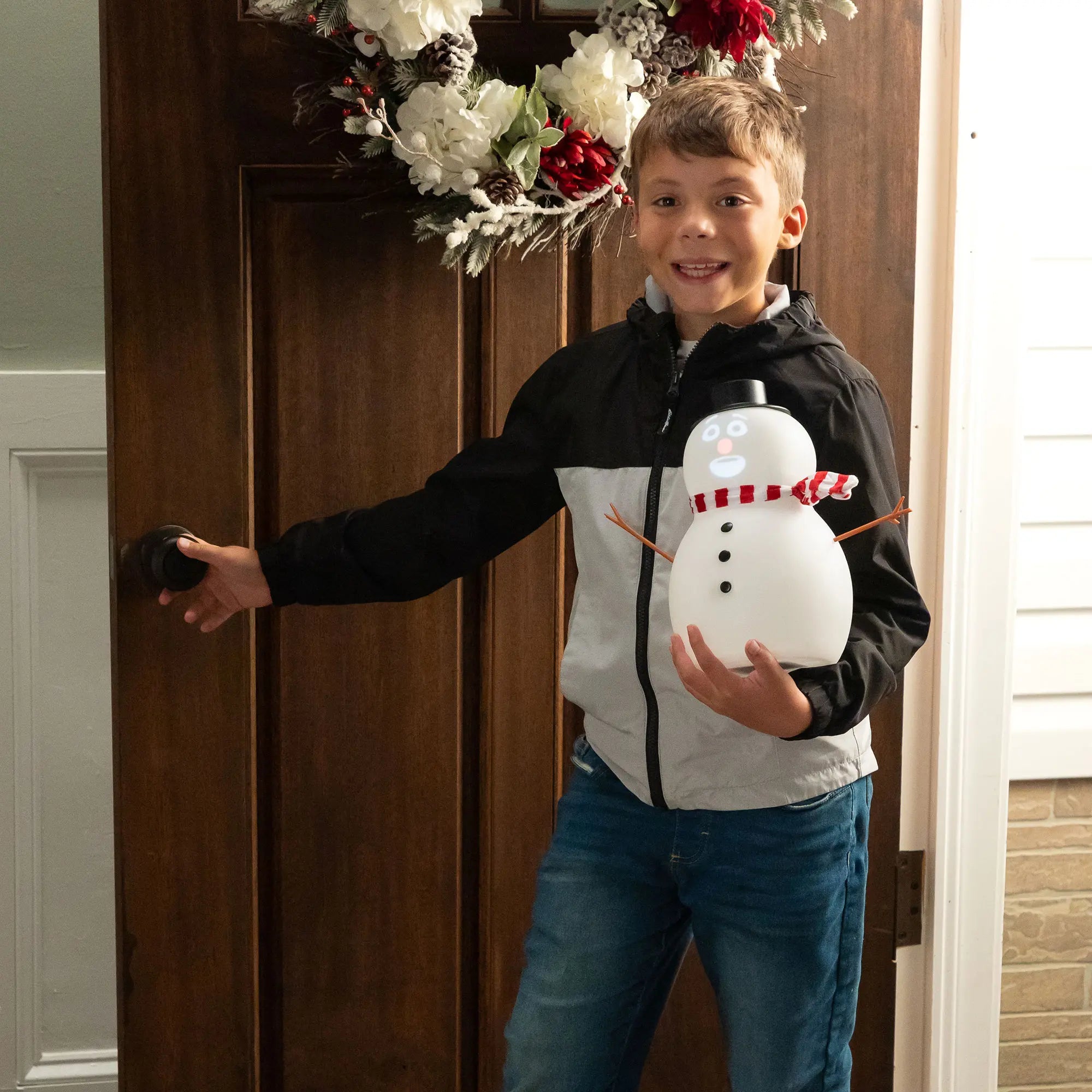 Child carrying FrostByte animated talking snowman